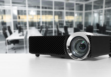 Modern video projector on white table in officeの写真素材