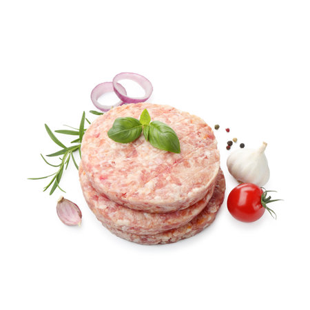 Fresh raw patties for burger, tomato and spices isolated on white, above viewの写真素材