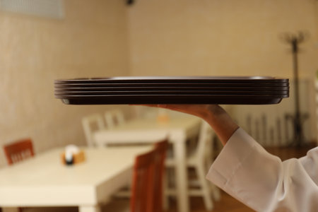 School canteen worker holding plastic trays for food indoors, closeupの写真素材