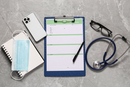 Flat lay composition with medical card form on grey backgroundの写真素材