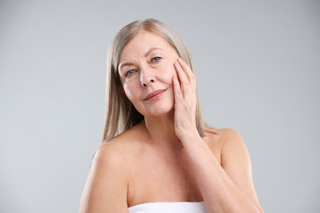 Woman with healthy skin on grey backgroundの写真素材