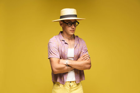 Fashionable portrait of handsome man in stylish outfit on color background