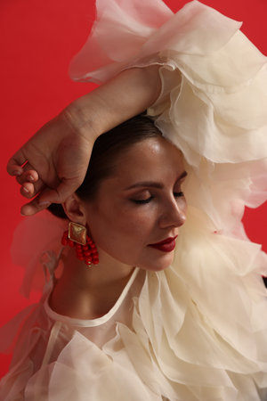 Young woman in stylish clothes on red backgroundの写真素材