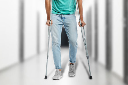 Man with crutches in hospital, closeup