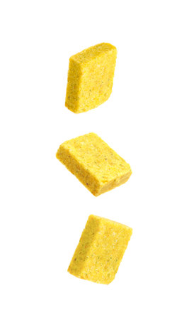 Bouillon cubes in air on white background