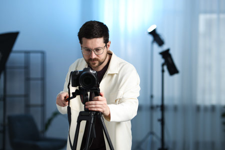 Man with professional video camera in studio