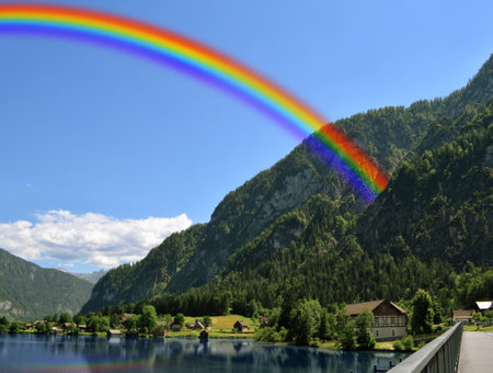 Bright colorful rainbow in sky over countryside. Beautiful landscapeの写真素材