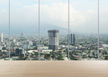 Empty table near window with city view in office