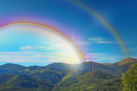 Bright colorful double rainbow in sky over mountains. Beautiful landscapeの写真素材