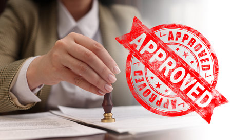 Woman stamping document at table and red stamp Approved, banner designの写真素材