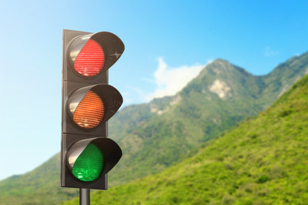 Traffic lights against mountain in countryside. Signaling device