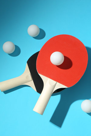 Ping pong rackets and balls on light blue background, flat layの写真素材