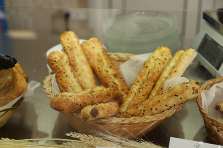 Wicker basket with bread sticks in school canteen. Tasty food