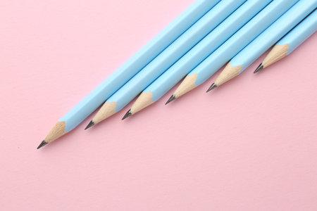 Many graphite pencils on pink background, flat layの写真素材
