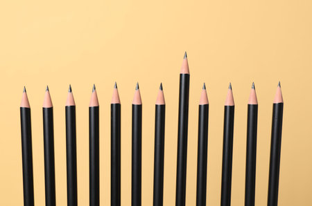 Many sharp graphite pencils on beige background, closeupの写真素材