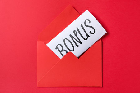 Card with word Bonus in envelope on red background, top viewの写真素材