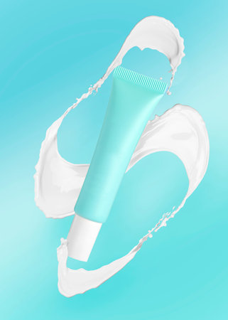Tube and splash of cosmetic product in air on light blue backgroundの写真素材