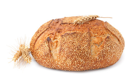 Fresh bread with sesame seeds and spikes isolated on whiteの写真素材