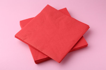 Stack of red handkerchiefs on pink background, closeupの写真素材