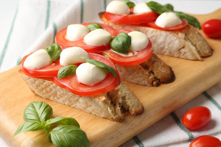 Tasty sandwiches with mozzarella cheese, tomatoes and basil on table, closeupの写真素材