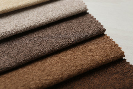 Samples of different fabrics on light wooden table, closeupの写真素材