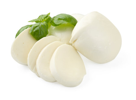 Pieces of mozzarella cheese and basil isolated on whiteの写真素材