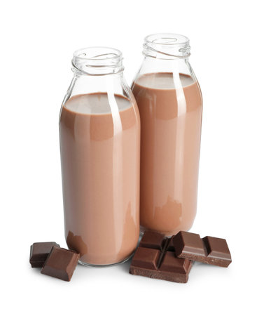 Tasty chocolate milk in glass bottles and pieces isolated on whiteの写真素材