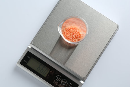 Laboratory scale with beaker of sample on white background, top viewの写真素材