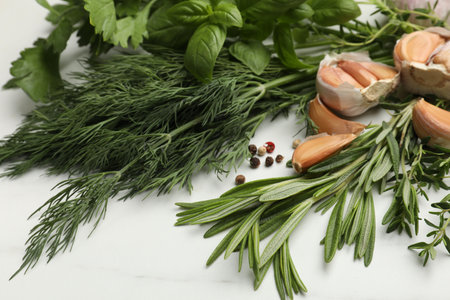 Different fresh herbs and spices on white table, closeupの写真素材