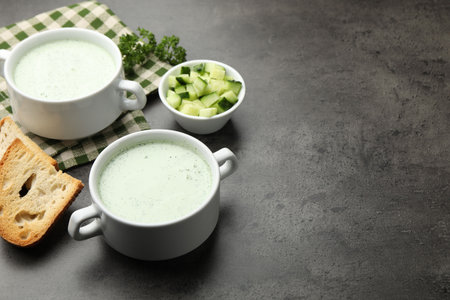 Tasty cucumber soup served on grey table. Space for textの写真素材