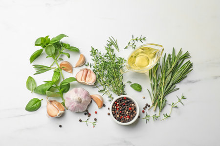 Different fresh herbs and spices on white marble table, flat layの写真素材