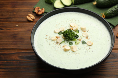Tasty cucumber soup with croutons and broccoli on wooden table, closeupの写真素材