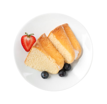 Pieces of tasty bundt cake with berries isolated on white, top viewの写真素材