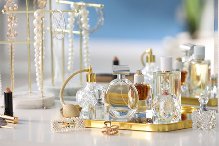 Bottles of different perfumes and accessories on table indoorsの写真素材