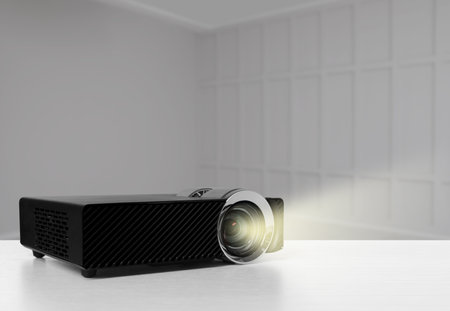 Modern video projector on white table in roomの写真素材