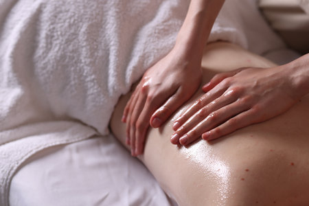 Woman receiving back massage with oil in spa salon, closeupの写真素材