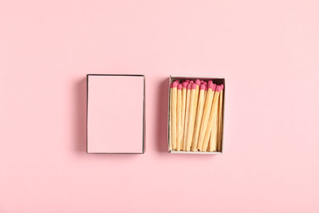 Matches and box on pink background, flat lay. Mockup for designの写真素材