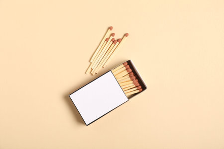 Matches and box on beige background, flat lay. Mockup for design