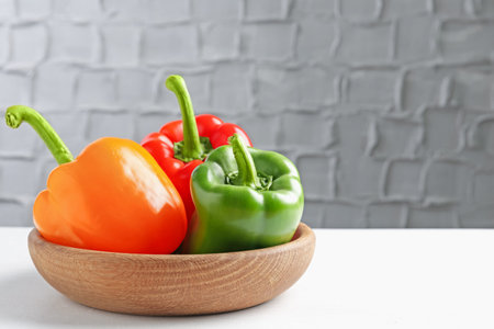 Ripe colorful bell peppers on white table. Space for textの写真素材