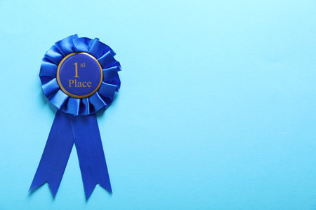 One award ribbon on light blue background, top view. Space for textの写真素材