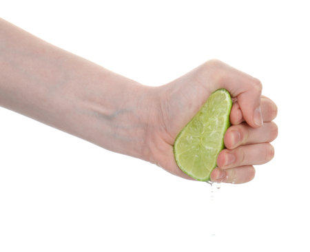 Woman squeezing lime on white background, closeupの写真素材