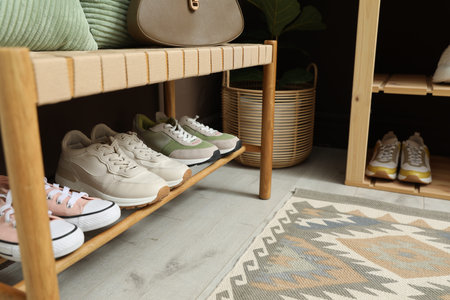 Different footwear on bench indoors. Shoe storageの写真素材