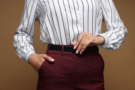 Confident business woman on brown background, closeupの写真素材