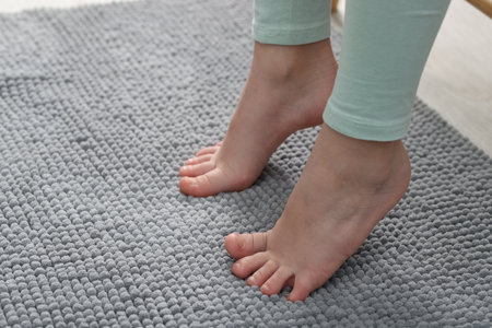 Girl on soft carpet at home, closeup. Space for textの写真素材
