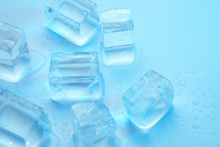 Cubes of clear ice on light blue background, closeupの写真素材