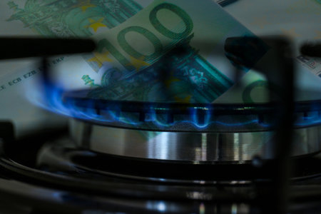 Gas burner with blue flame and euro bills, double exposure. Gas tariffの写真素材