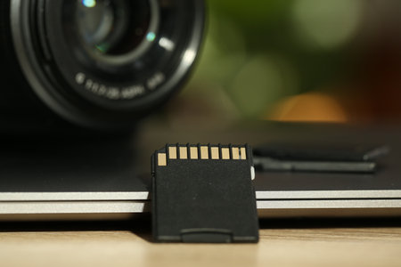 SD memory card, holder, photo camera and laptop on table, closeupの写真素材