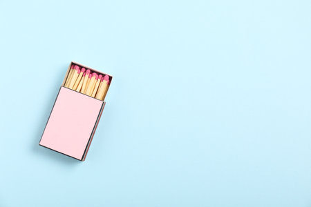 Matches in box on light blue background, top view. Mockup for designの写真素材
