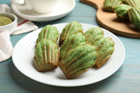 Tasty matcha madeleine cakes on light blue wooden table, closeupの写真素材