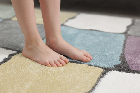 Girl on soft carpet at home, closeupの写真素材